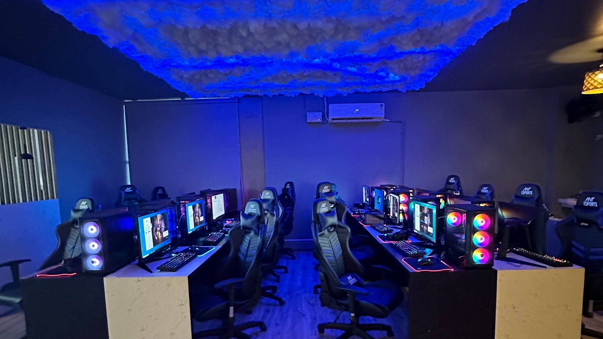 Rows of gaming PCs and RGB-lit machines inside the cafe